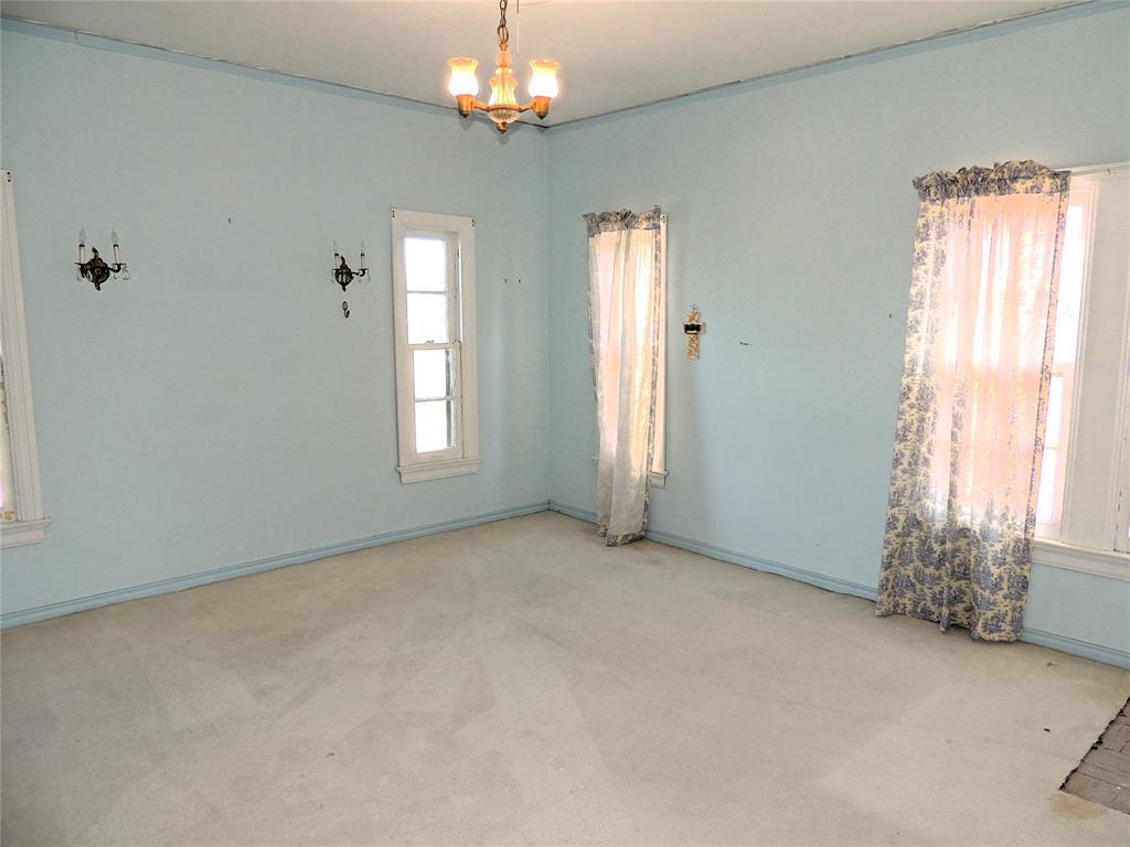 2102 Swenson Street Abilene, TX 79603 - Photo 26 of 40 an empty room with windows and chandelier fan