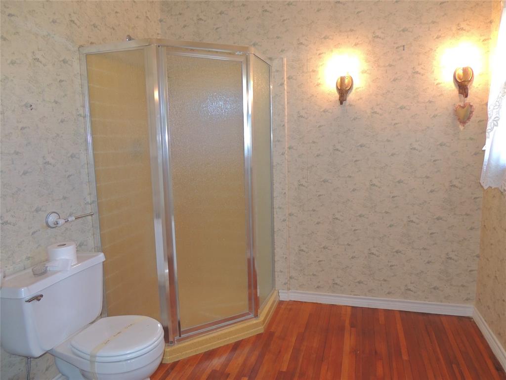 2102 Swenson Street Abilene, TX 79603 - Photo 29 of 40 a bathroom with a granite countertop toilet and a sink