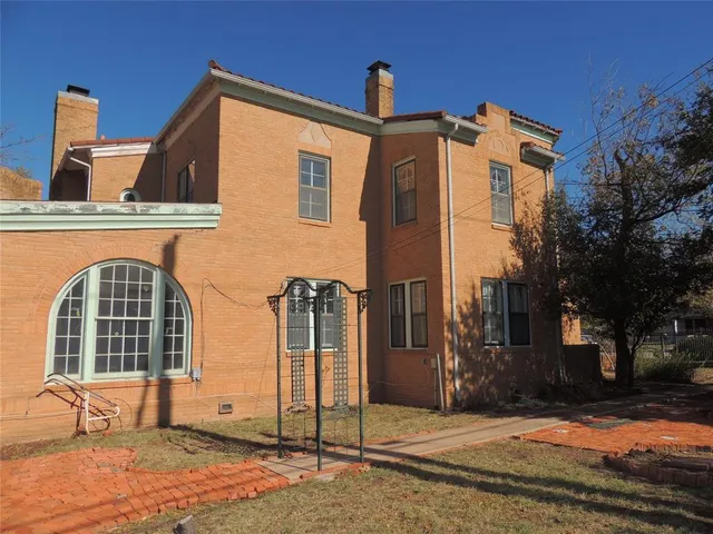 a view of a building with a yard