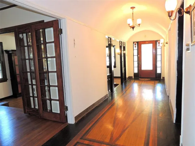 a view of hallway with stairs and wooden floor