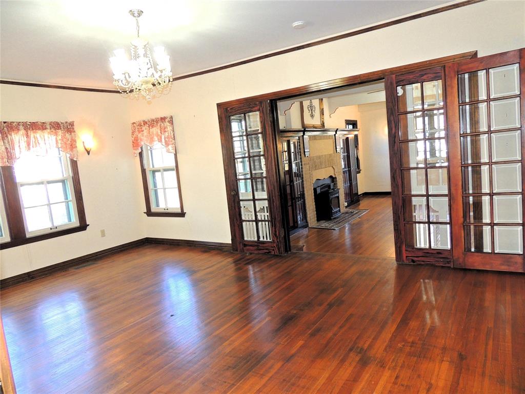 2102 Swenson Street Abilene, TX 79603 - Photo 9 of 40 an empty room with wooden floor and windows