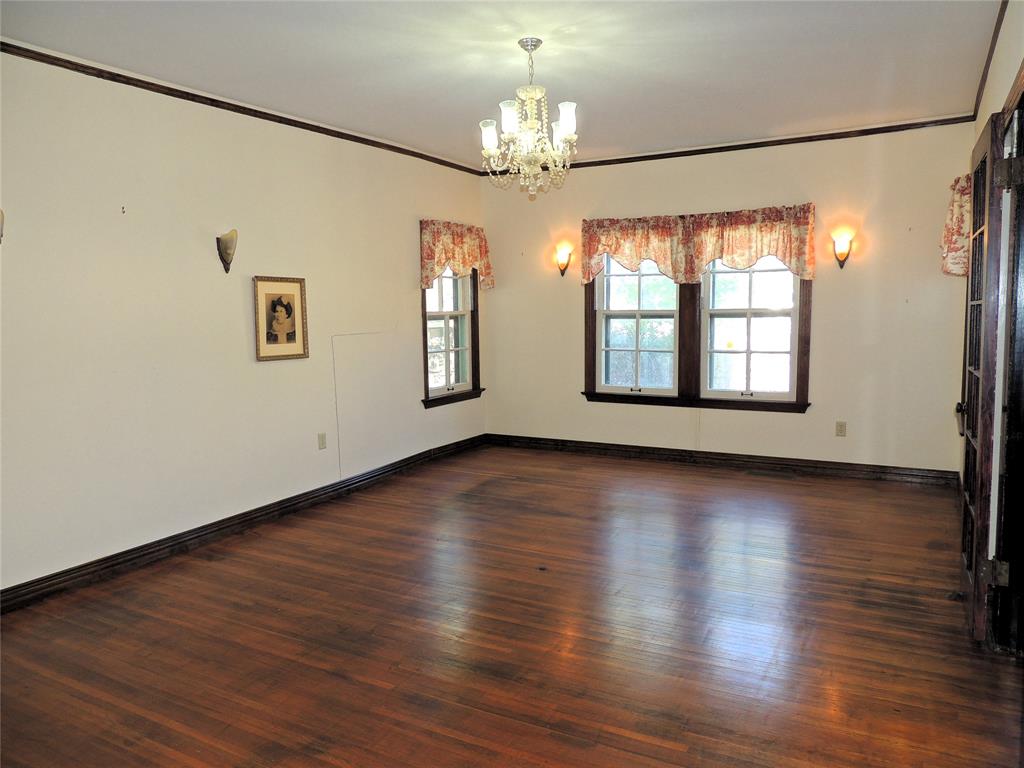 2102 Swenson Street Abilene, TX 79603 - Photo 10 of 40 an empty room with wooden floor and windows