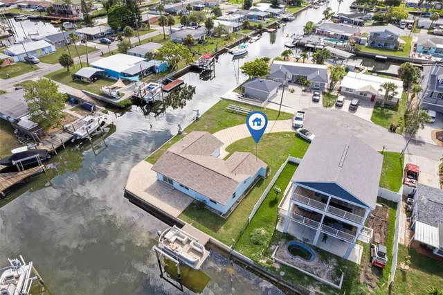 an aerial view of a swimming pool with outdoor seating