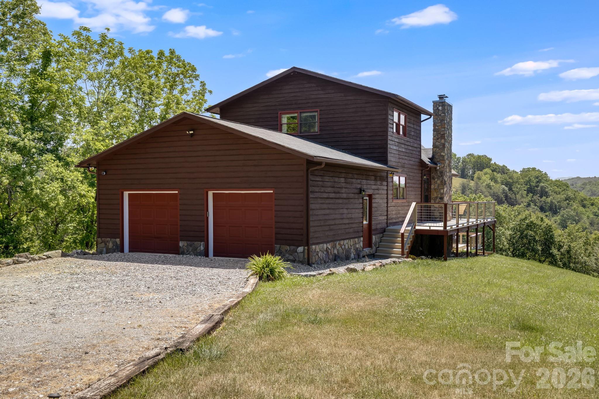 694 Boulder Road Marshall, NC 28753 - Photo 6 of 44 a front view of a house with a yard and garage
