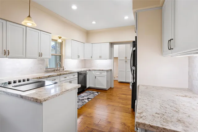 a kitchen with stainless steel appliances granite countertop a stove a sink and a refrigerator