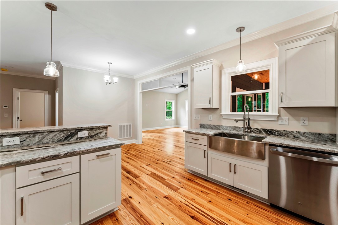 110 Gabriel Way Pickens, SC 29671 - Photo 9 of 48 A well-lit kitchen with natural wood flooring and ample counter space.