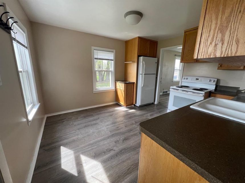 7375 Coon Trail Road Capron, IL 61012 - Photo 7 of 14 a kitchen with a refrigerator and a stove top oven