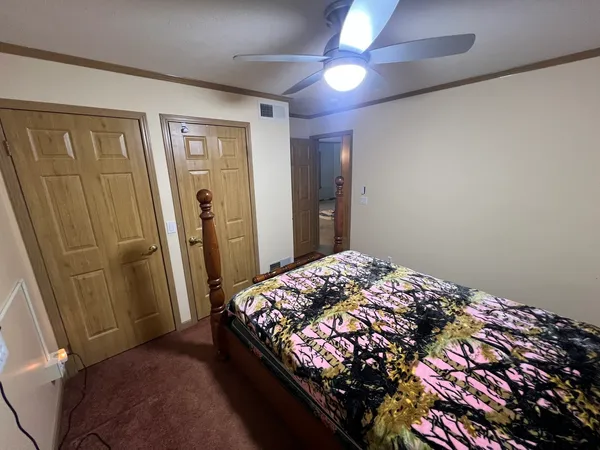 a bedroom with a bed and a mirror