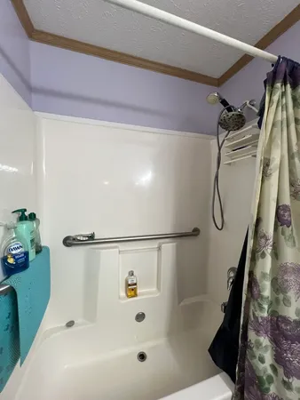 a bathroom with a shower and a bath tub