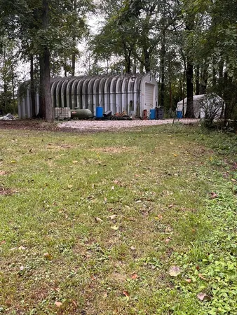 a view of a yard with wooden fence