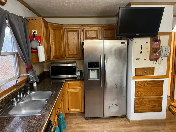 a kitchen with stainless steel appliances granite countertop a refrigerator and a sink