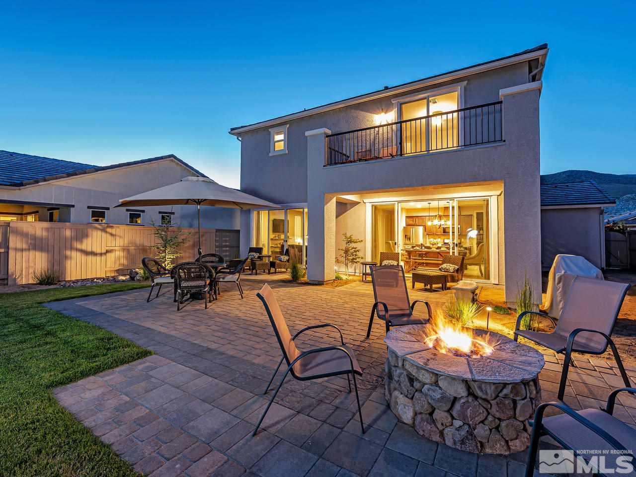3110 Show Jumper Lane Reno, NV 89521 - Photo 2 of 28 a view of a patio with table and chairs under an umbrella