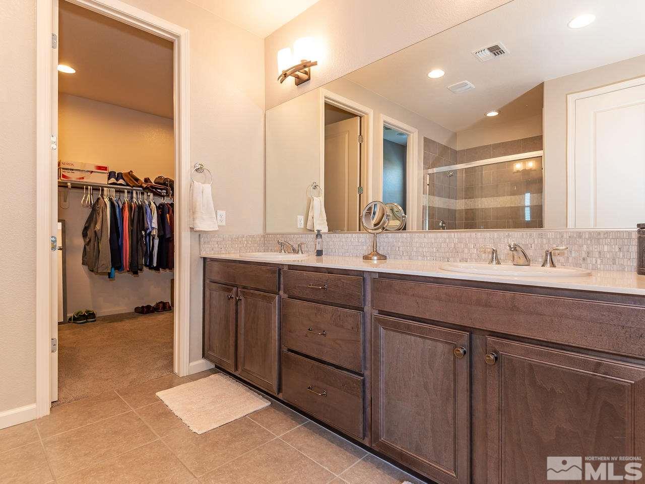 3110 Show Jumper Lane Reno, NV 89521 - Photo 23 of 28 a bathroom with a double vanity sink and a mirror