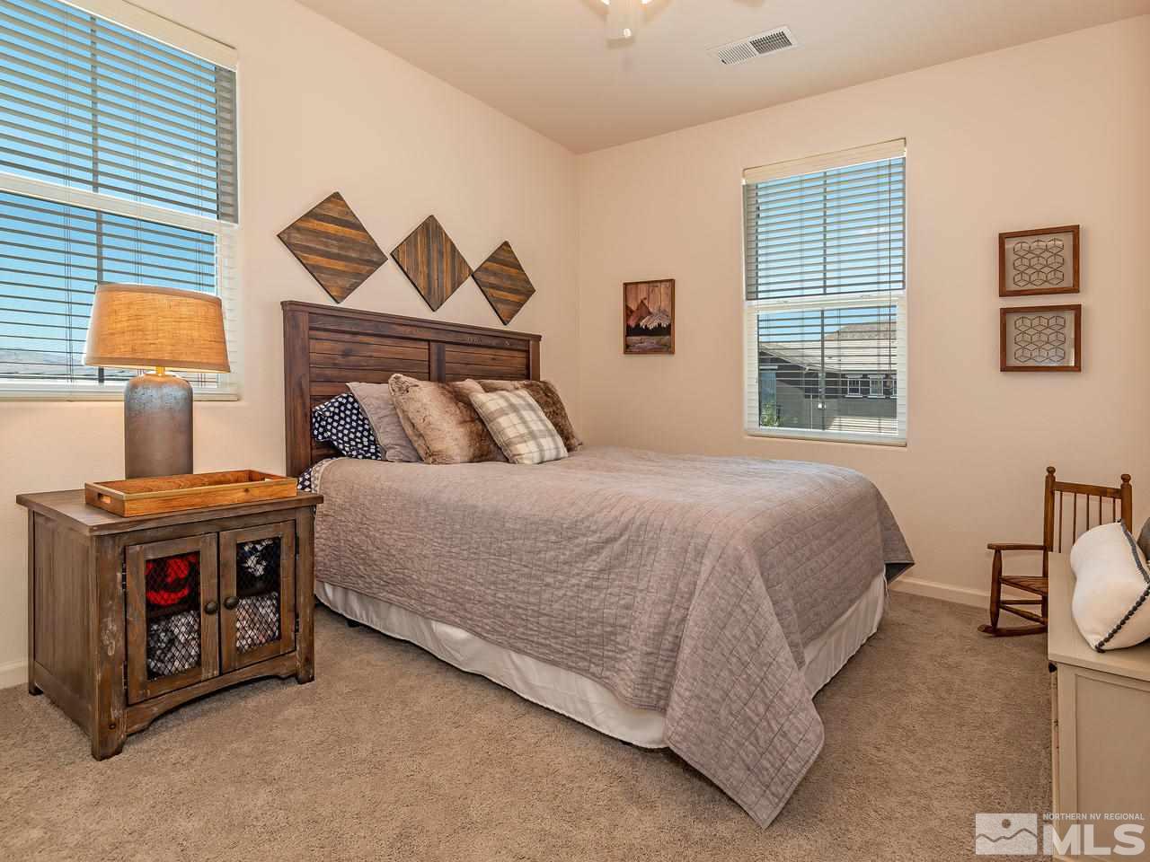 3110 Show Jumper Lane Reno, NV 89521 - Photo 24 of 28 a bed sitting in a bedroom next to a window