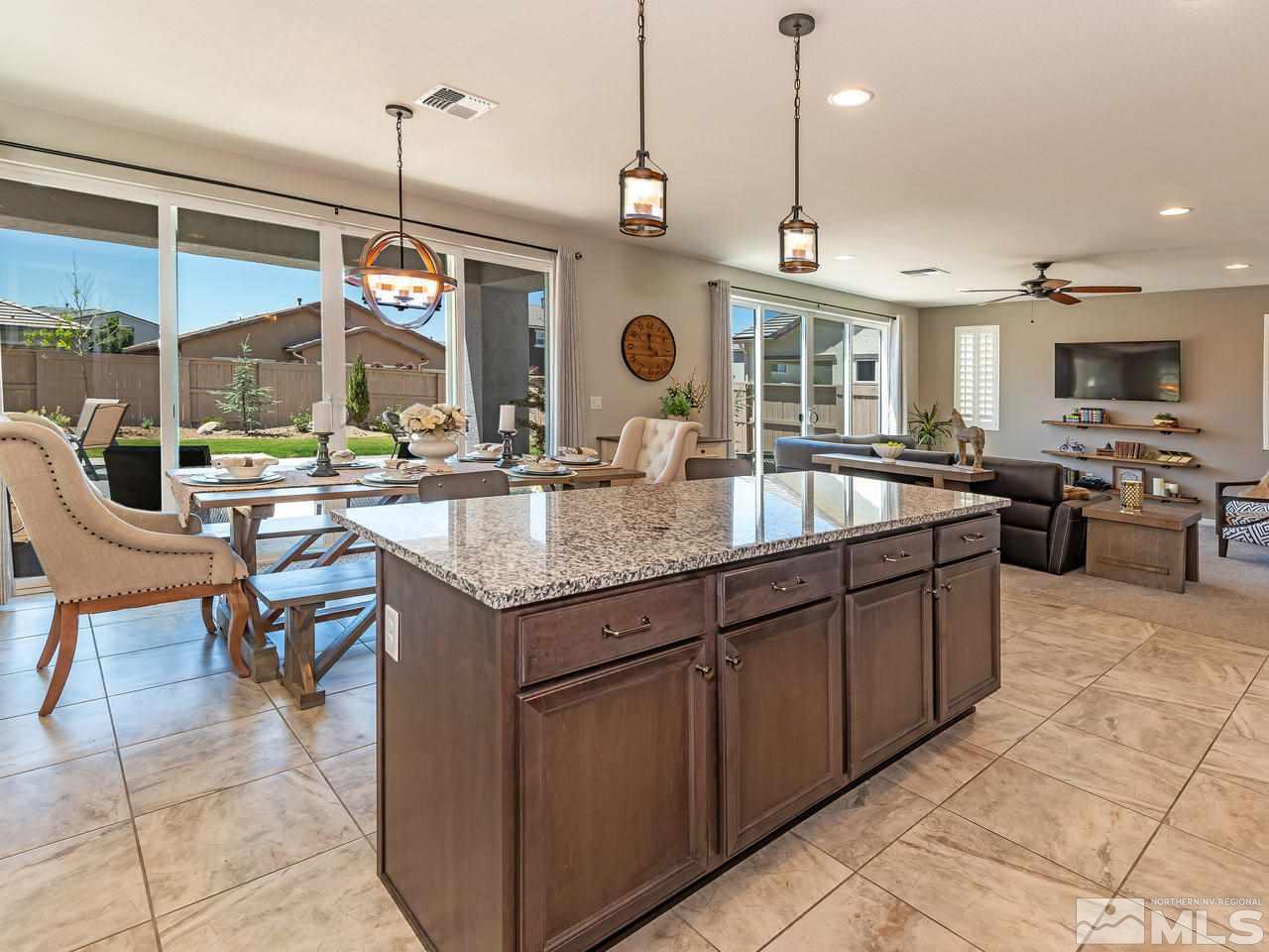 3110 Show Jumper Lane Reno, NV 89521 - Photo 7 of 28 a kitchen with a stove a kitchen island a dining table and chairs