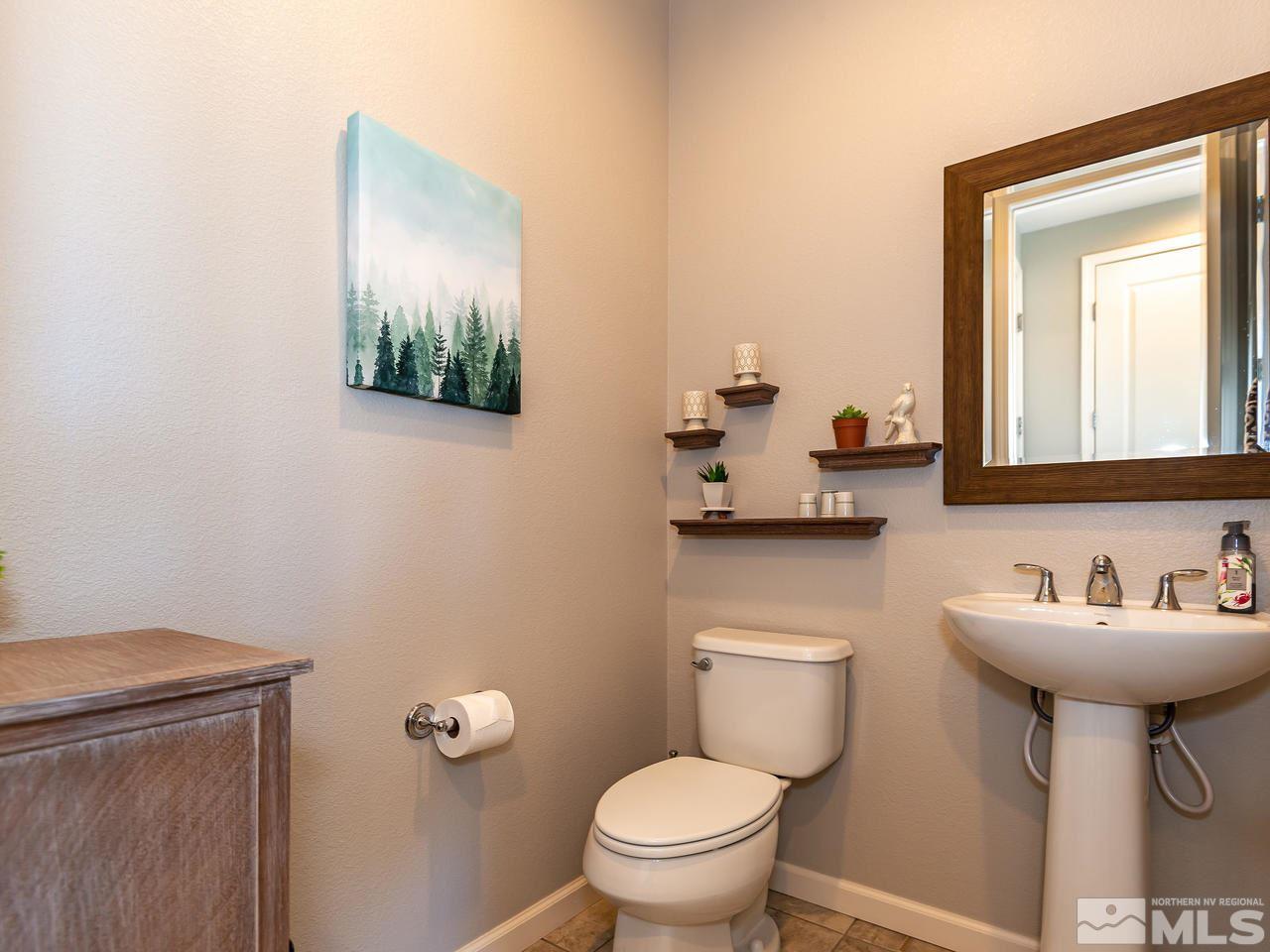 3110 Show Jumper Lane Reno, NV 89521 - Photo 10 of 28 a bathroom with a toilet a sink and mirror