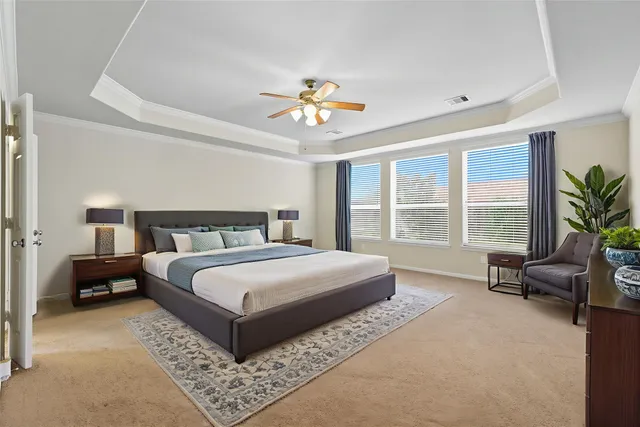 a bedroom with a large bed and a couch