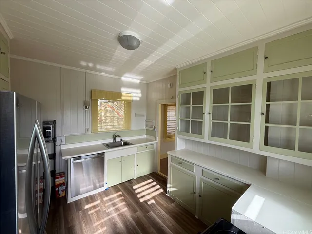 a kitchen with a sink stainless steel appliances and cabinets