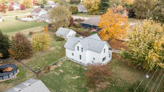 a view of a house with a tree in front of it