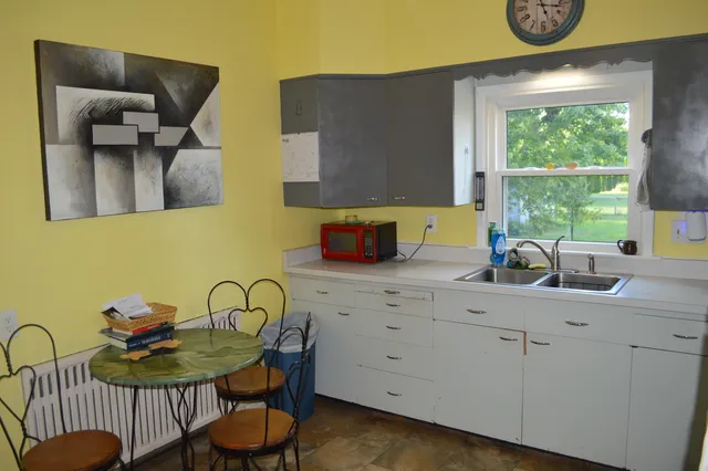 a bathroom with a sink a toilet and shower curtain
