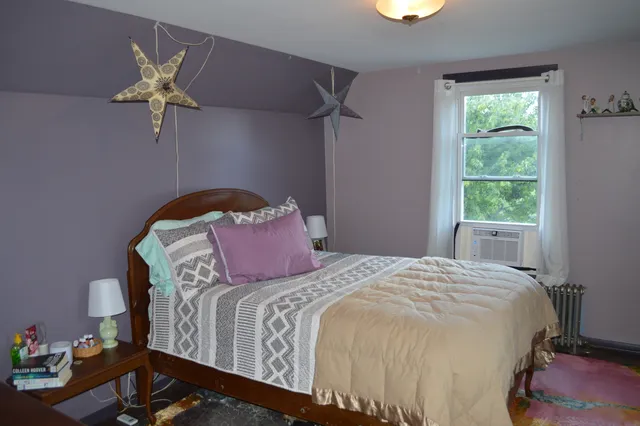 a view of a small house with yard and a garden