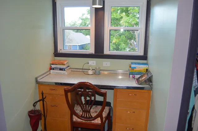 a view of a house with a big yard and large trees