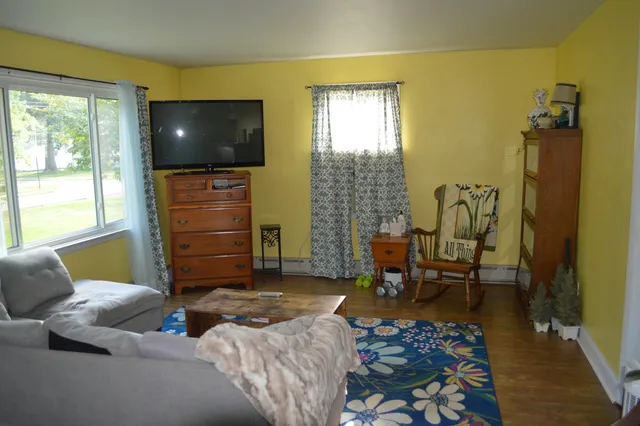a kitchen with a table chairs and a window
