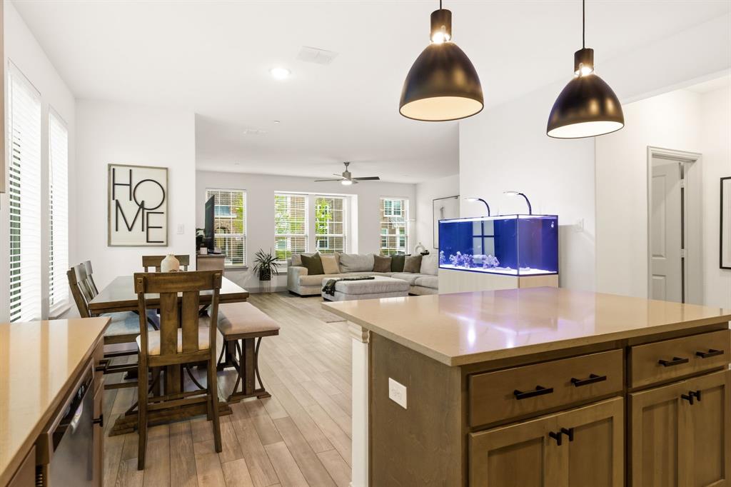 3720 Dutchess Drive Frisco, TX 75034 - Photo 16 of 36 a kitchen with stainless steel appliances a table chairs and a wooden floor