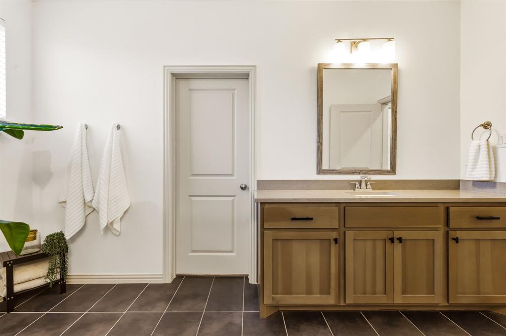 3720 Dutchess Drive Frisco, TX 75034 - Photo 20 of 36 a bathroom with a sink and a mirror