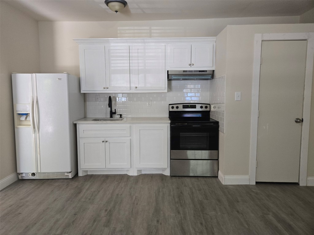 19639 Maple Lane New Caney, TX 77357 - Photo 15 of 18 a kitchen with a refrigerator stove and white cabinets