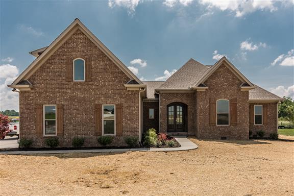 657 Jackson Road Portland, TN 37148 - Photo 1 of 30 a front view of a house with a yard and garage