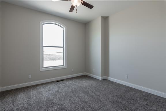 657 Jackson Road Portland, TN 37148 - Photo 17 of 30 an empty room with windows and chandelier fan