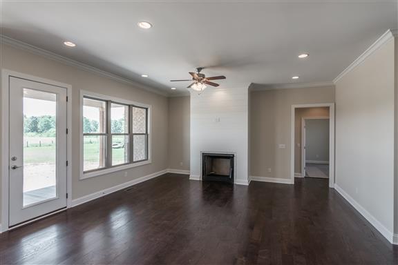 657 Jackson Road Portland, TN 37148 - Photo 4 of 30 an empty room with wooden floor and windows