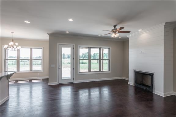 657 Jackson Road Portland, TN 37148 - Photo 5 of 30 an empty room with wooden floor and a fireplace