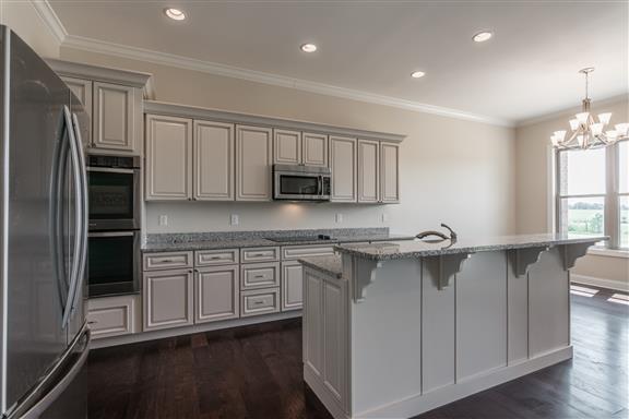 657 Jackson Road Portland, TN 37148 - Photo 7 of 30 a kitchen with stainless steel appliances granite countertop a stove a sink and a refrigerator