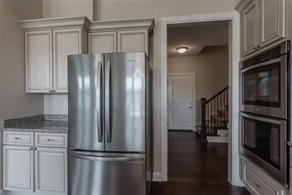 657 Jackson Road Portland, TN 37148 - Photo 8 of 30 a metallic refrigerator freezer sitting in a kitchen