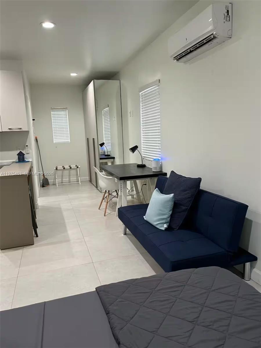 245 Northeast 33rd Street, Unit 207 Miami, FL 33137 - Photo 2 of 6 a living room with furniture and wooden floor