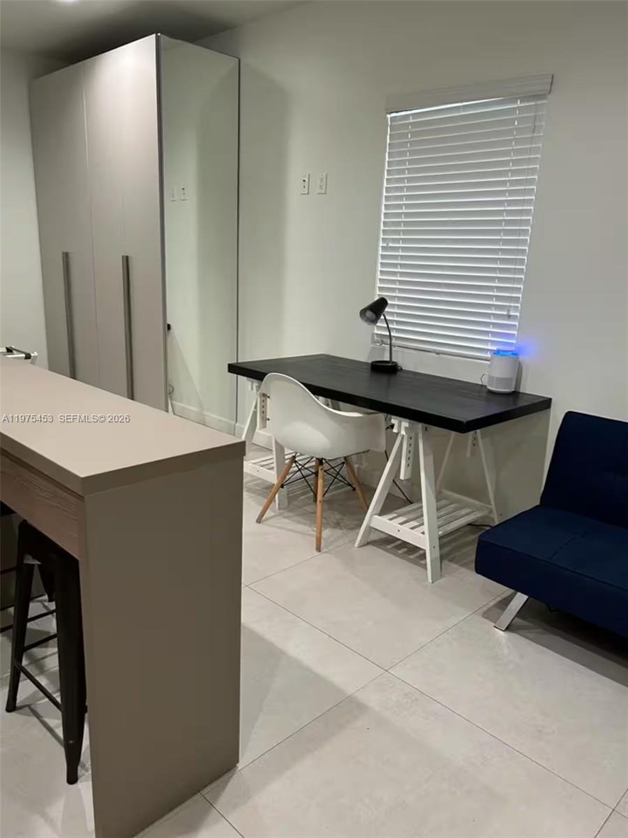 245 Northeast 33rd Street, Unit 207 Miami, FL 33137 - Photo 5 of 6 a workspace with furniture and window
