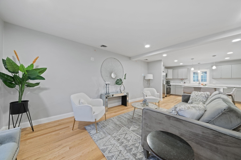 6 Simmonds Boulevard, Unit 6 Randolph, MA 02368 - Photo 8 of 28 a living room with furniture potted plant and a wooden floor