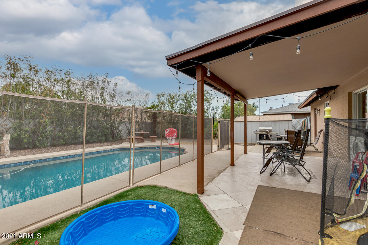 4215 West Dailey Street Phoenix, AZ 85053 - Photo 26 of 32 a view of a porch with furniture and a backyard