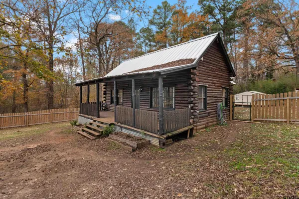a view of a small house and a yard