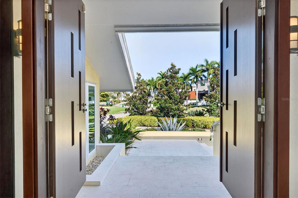 1571 Harbor Cay Lane Longboat Key, FL 34228 - Photo 11 of 93 a view of a potted plant in front of a glass door