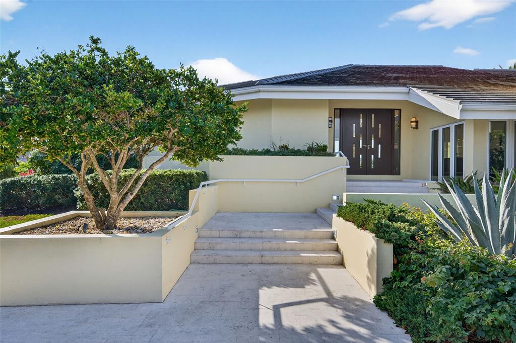 1571 Harbor Cay Lane Longboat Key, FL 34228 - Photo 14 of 93 a front view of a house with garden