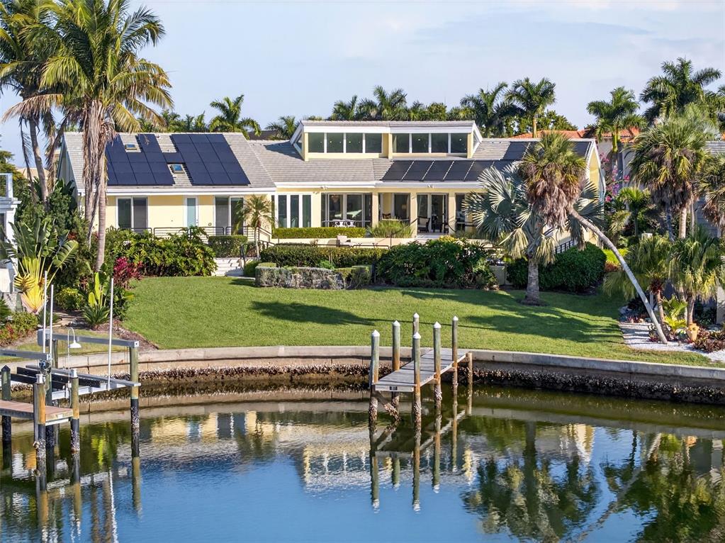 1571 Harbor Cay Lane Longboat Key, FL 34228 - Photo 2 of 93 a view of a swimming pool with lawn chairs and plants