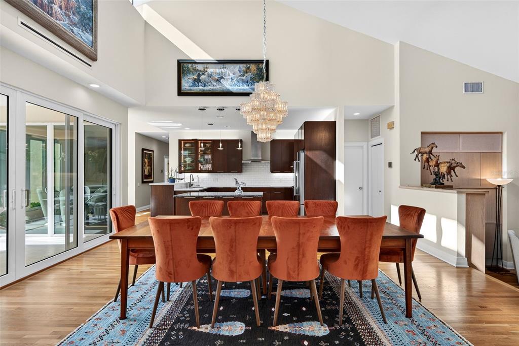 1571 Harbor Cay Lane Longboat Key, FL 34228 - Photo 22 of 93 a dining room with furniture a fireplace and wooden floor