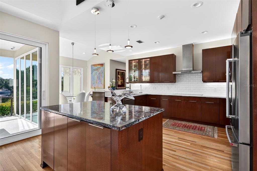 1571 Harbor Cay Lane Longboat Key, FL 34228 - Photo 23 of 93 a kitchen with stainless steel appliances granite countertop a sink counter space and living room view