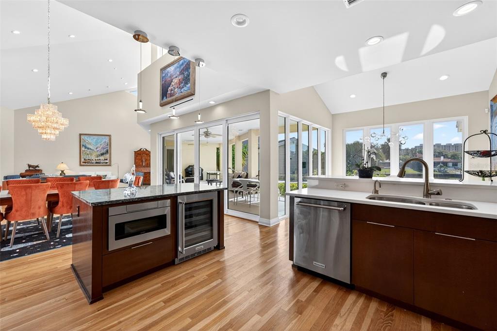1571 Harbor Cay Lane Longboat Key, FL 34228 - Photo 27 of 93 a large kitchen with stainless steel appliances a stove a sink dishwasher and a large oven with wooden floor