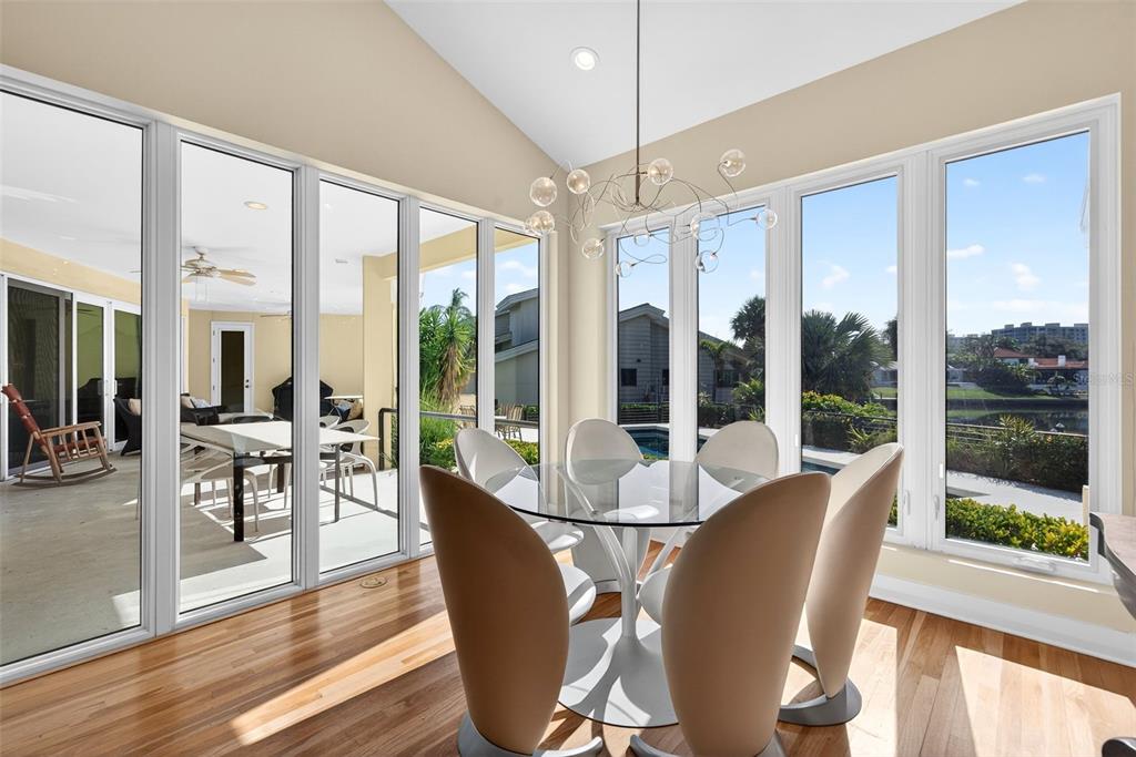 1571 Harbor Cay Lane Longboat Key, FL 34228 - Photo 31 of 93 a view of a dining room with furniture large windows and wooden floor