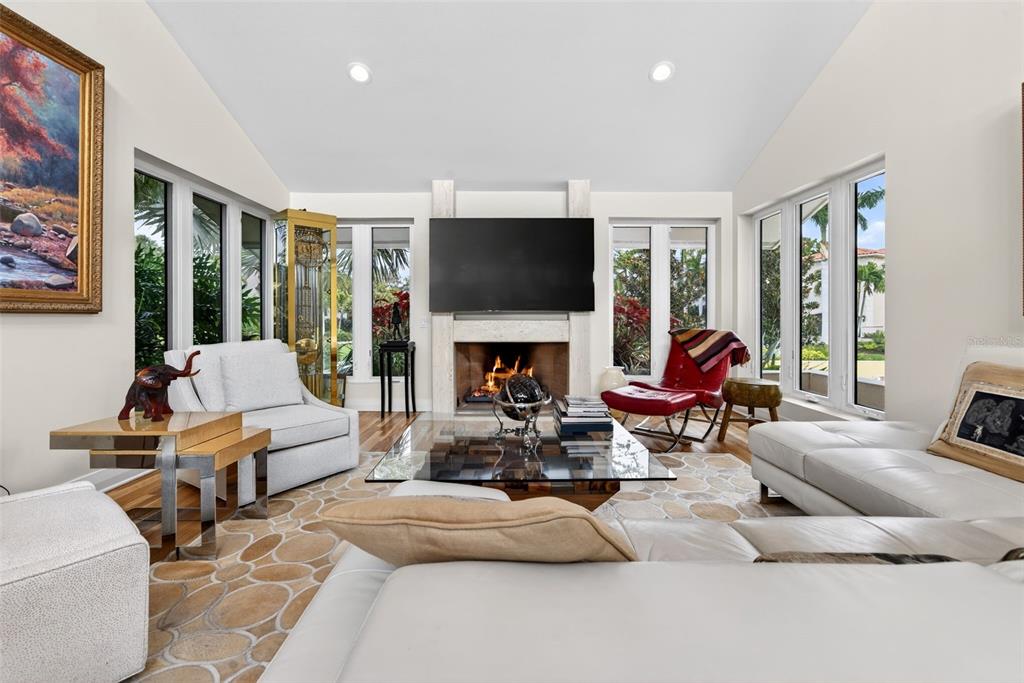 1571 Harbor Cay Lane Longboat Key, FL 34228 - Photo 34 of 93 a living room with fireplace furniture and a flat screen tv