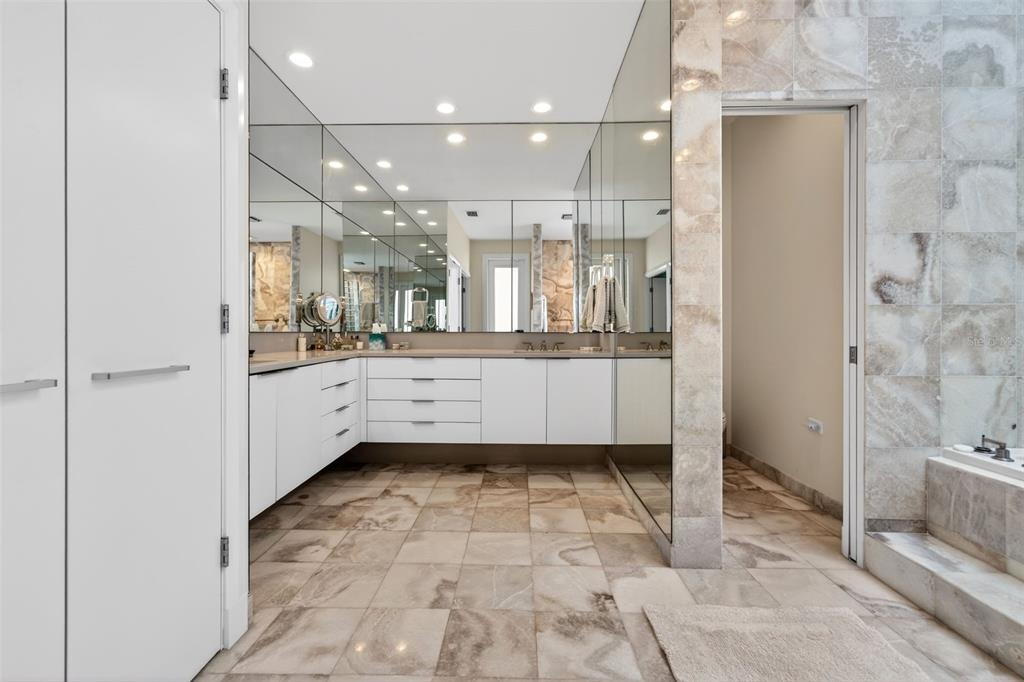 1571 Harbor Cay Lane Longboat Key, FL 34228 - Photo 40 of 93 a bathroom with a sink a mirror and a shower